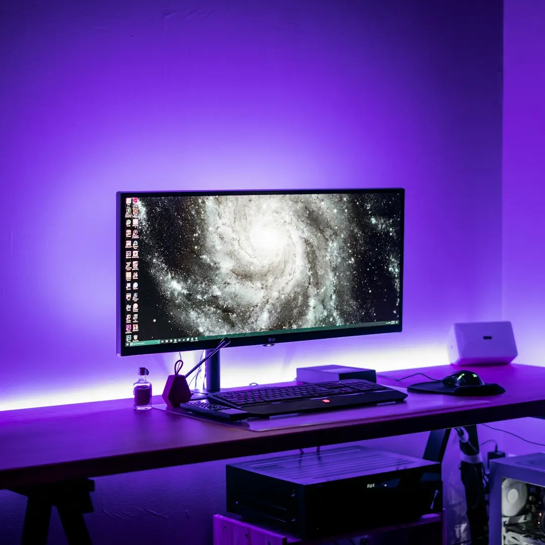 flat screen computer monitor on brown computer desk
